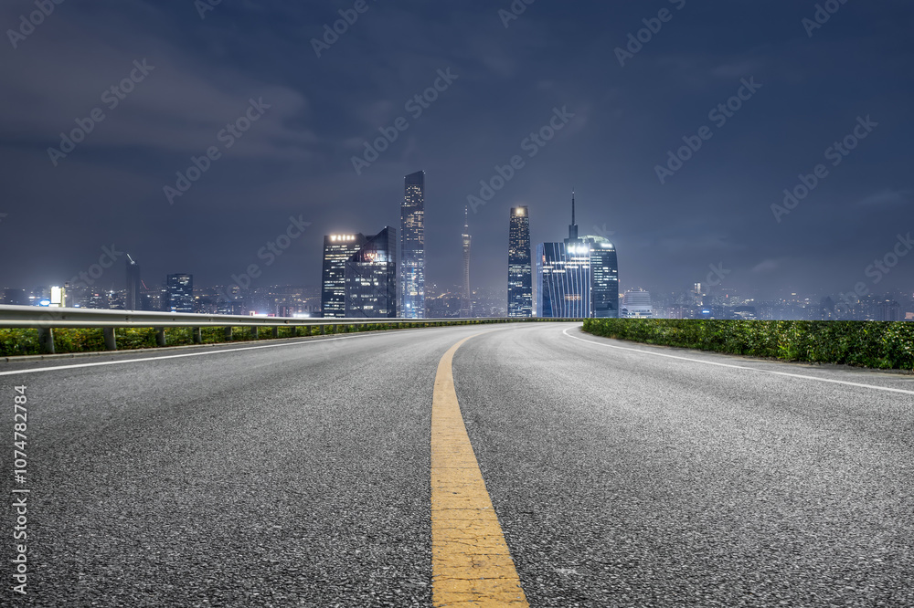 Nighttime Cityscape with Curved Road Leading to Skyline Nighttime Cityscape with Curved Road Leading to Skyline