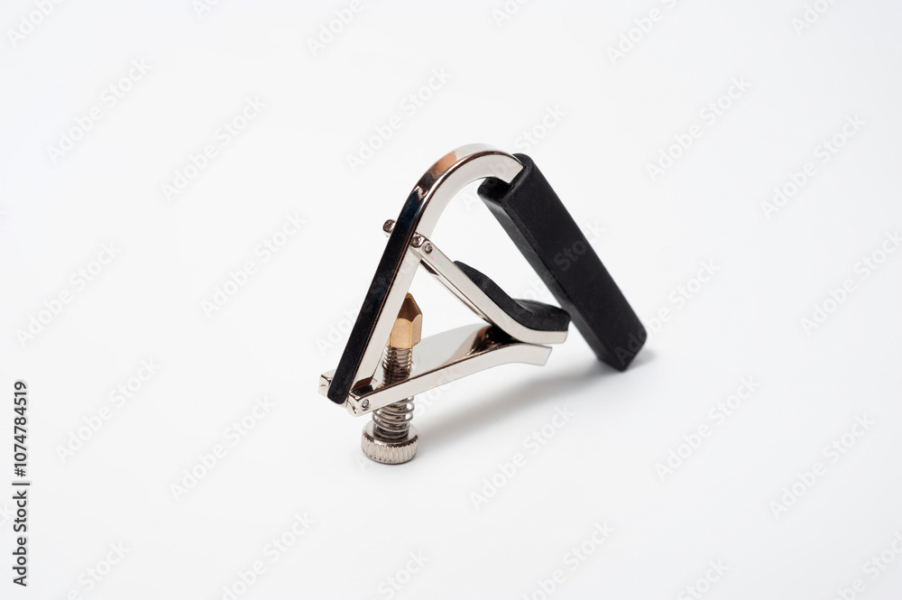 Modern technological, metal capo with a spring clamp for guitar. Modern technological, metal capo with a spring clamp for guitar.