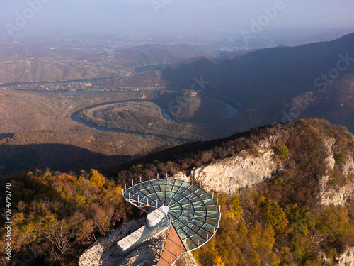 Aerial scenic view of modern and futuristic glass skywalk viewpoint, extending over mountain Ovcar and Kablar canyon in Serbia. Meanders of West Morava river. Ovcarsko-Kablarska gorge.