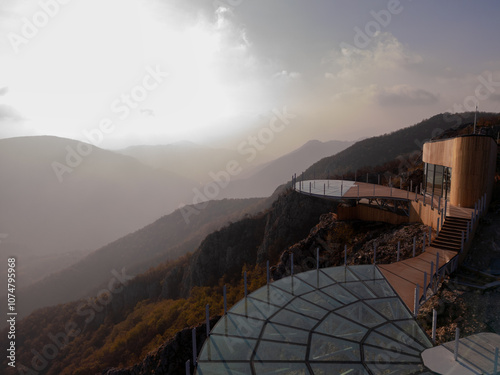 Aerial scenic view of modern and futuristic glass skywalk viewpoint, extending over mountain Ovcar and Kablar canyon in Serbia. Meanders of West Morava river. Ovcarsko-Kablarska gorge. photo