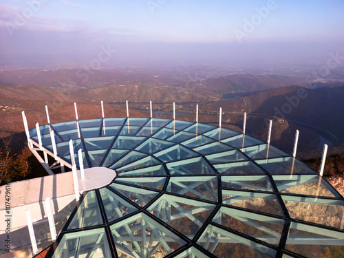 Aerial scenic view of modern and futuristic glass skywalk viewpoint, extending over mountain Ovcar and Kablar canyon in Serbia. Meanders of West Morava river. Ovcarsko-Kablarska gorge. photo