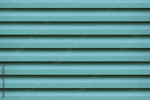 The green wooden vent lattice, serves as a vibrant background.
