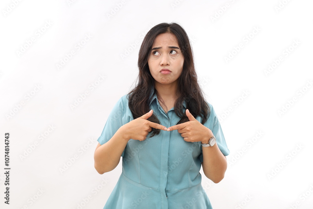 Hesitant indecisive pretty Asian woman keeps index finger opposite feels doubtful wears shirt focused above poses against white background thinks about something. Let me think for few minutes. Hesitant indecisive pretty Asian woman keeps index finger opposite feels doubtful wears shirt focused above poses against white background thinks about something. Let me think for few minutes.