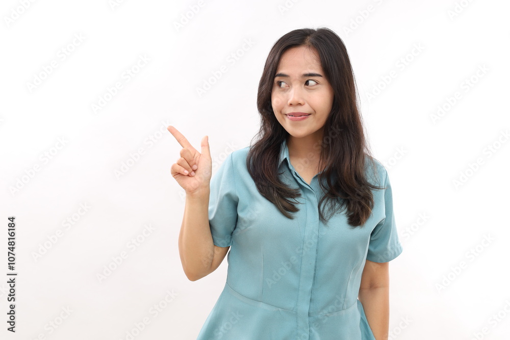 Look at this advert. Pleased young Asian woman points aside shows blank copy space for commercial text promo idea presentation poses against white background. Attention to nice product Look at this advert. Pleased young Asian woman points aside shows blank copy space for commercial text promo idea presentation poses against white background. Attention to nice product