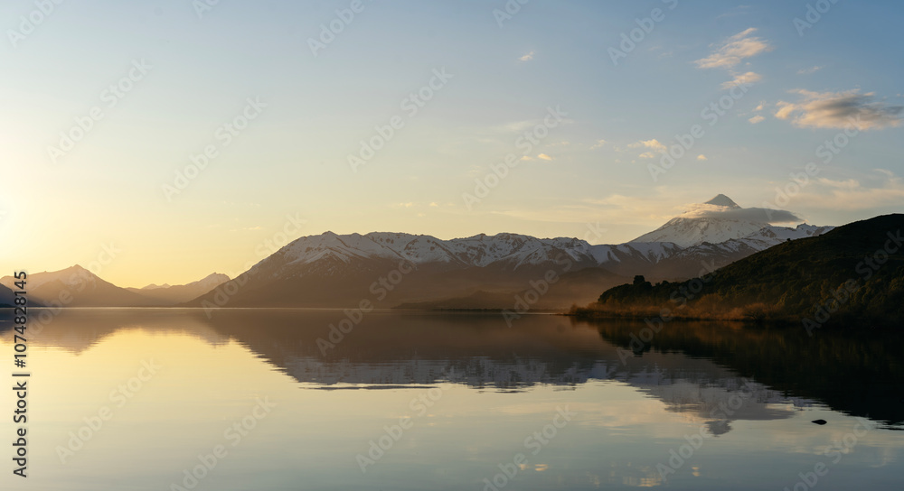 Obraz premium Majestic golden hour with snow capped mountains and calm water lake. Lanin National Park, Patagonia Argentina