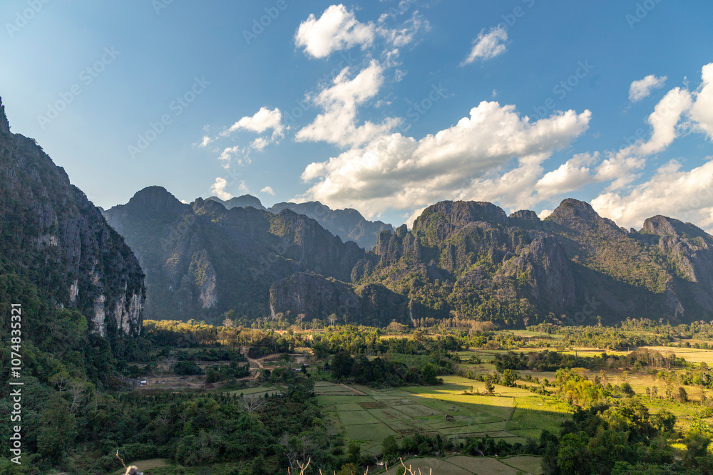 Obraz premium Countryside with farmland and karst mountains in the Vang Vieng. Vang Vieng, Vientiane Province, Laos