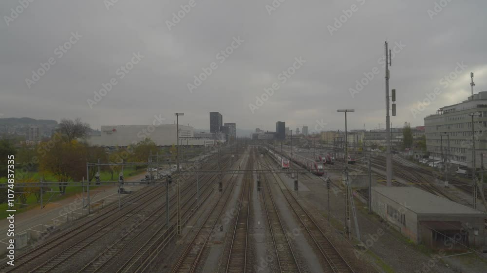 Skyline with cargo train loaded with gravel passing at Swiss City of Zürich on a foggy autumn day. Movie shot November 11th, 2024, Zurich, Switzerland. Skyline with cargo train loaded with gravel passing at Swiss City of Zürich on a foggy autumn day. Movie shot November 11th, 2024, Zurich, Switzerland.