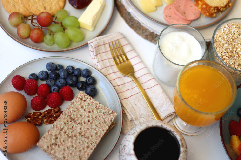 Assortment of various breakfast foods and drinks on the white table. Selective focus. Assortment of various breakfast foods and drinks on the white table. Selective focus.