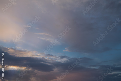 Summer evening sky in the picturesque clouds, lit by the rays of the setting sun.