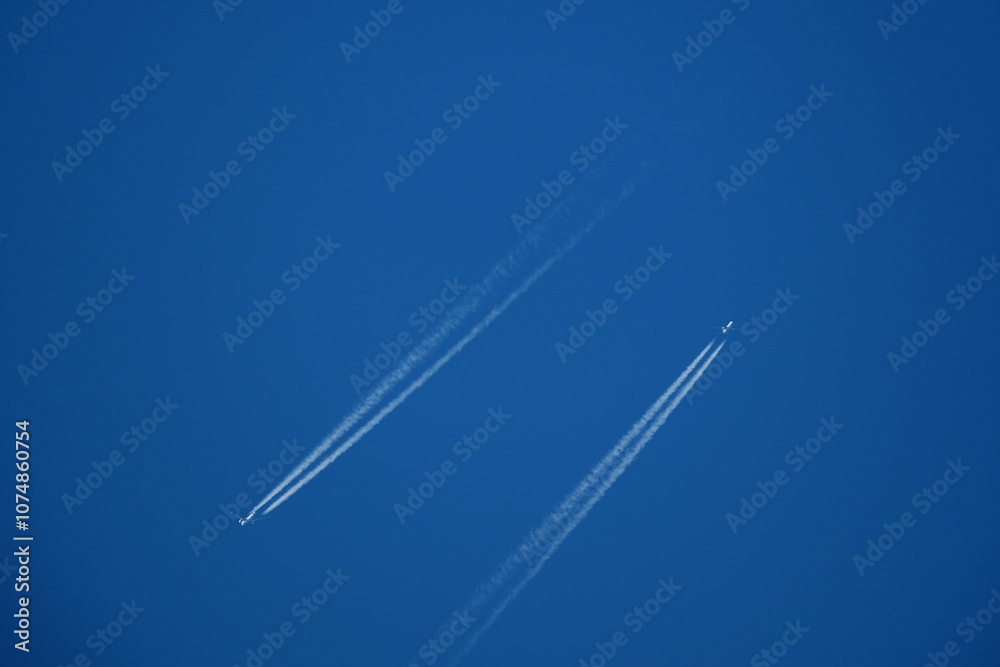 Airplanes in the blue sky with contrails. Shallow depth of field. Airplanes in the blue sky with contrails. Shallow depth of field.