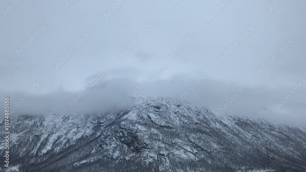 Time-lapse of clouds moving over a mountain range, showcasing dynamic weather and scenic beauty Time-lapse of clouds moving over a mountain range, showcasing dynamic weather and scenic beauty