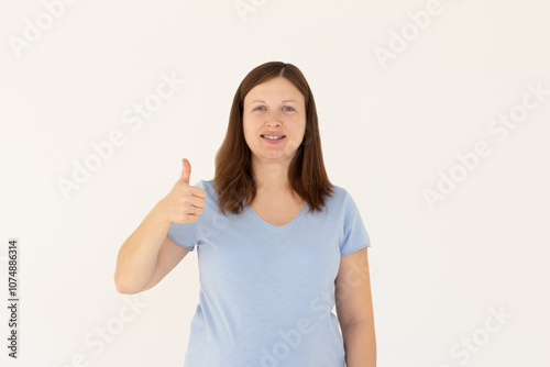 Saying yes. Smiling positive woman, showing thumb up to like and approve, praise good thing, recommending product, white background