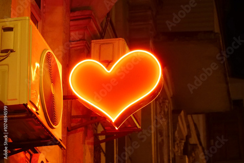 Bright red flashing heart on a night street photo