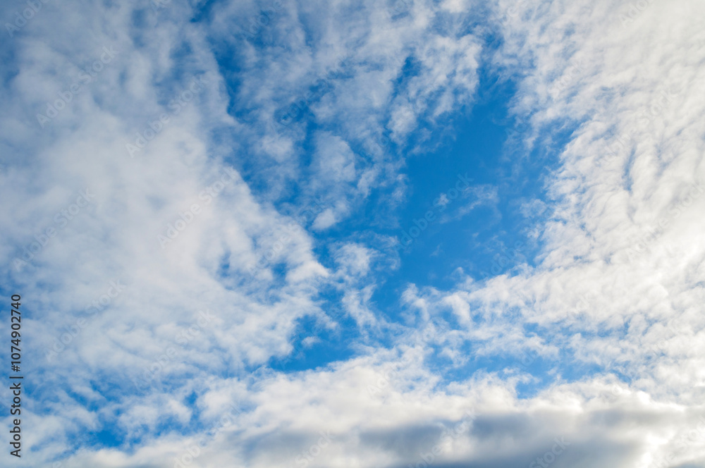 Fototapeta premium Blue sky sunset landscape with picturesque clouds lit by evening sunlight - colorful evening sky view