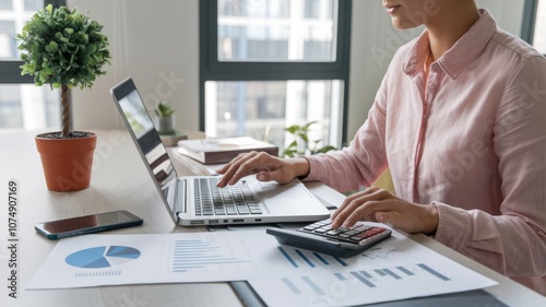 Wallpaper Mural Businesswoman Analyzing Financial Data with Calculator and Laptop Torontodigital.ca