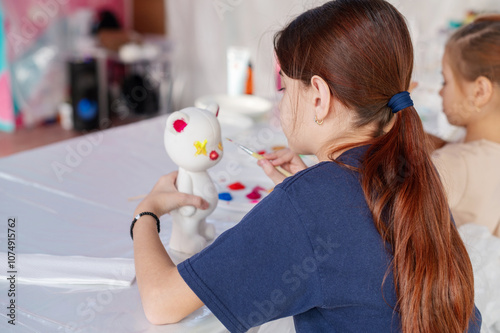 Group of primary school children paint a bearbrick with colorful water paints in the art class.Creative studio. No limits for creativity. photo