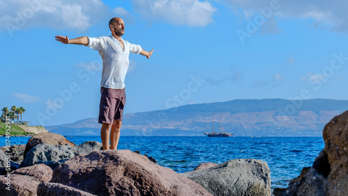 Photography A middle-aged charismatic man, wearing a white shirt, is relaxing and enjoying t