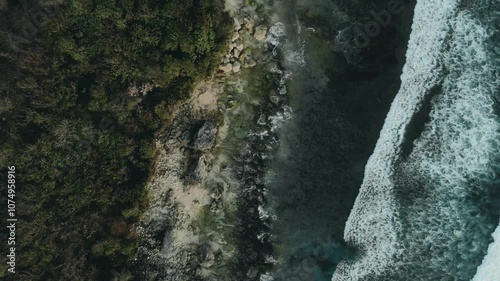 Top down aerial view of giant ocean waves crashing and foaming. Drone copter frame of darl gloomy sea and splashing waves. Travel, exotic tropic place. Tropical resort. Copy space. Fantastic adventure photo