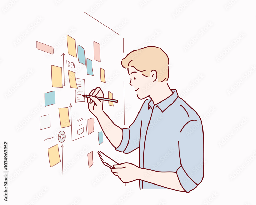  male employee write on colorful sticky notes develop business project in office, concentrated biracial man worker brainstorm engaged in creative thinking make startup plan.