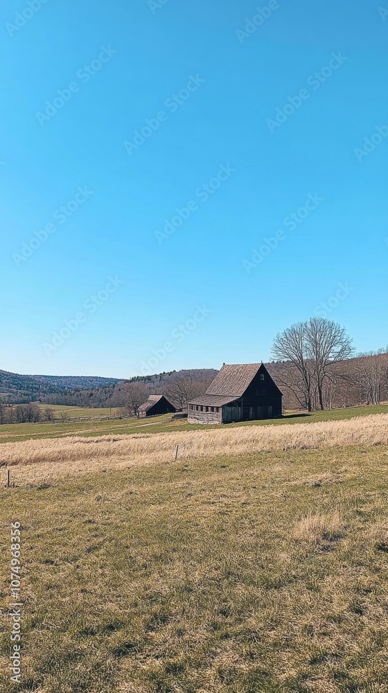 A stunning view of rolling hills with a rustic farmhouse under a clear blue sky in the countryside during daytime A stunning view of rolling hills with a rustic farmhouse under a clear blue sky in the countryside during daytime