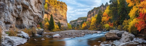 A breathtaking panorama of Spearfish Canyon showcasing vibrant fall colors reflecting in the water under a cloudy sky