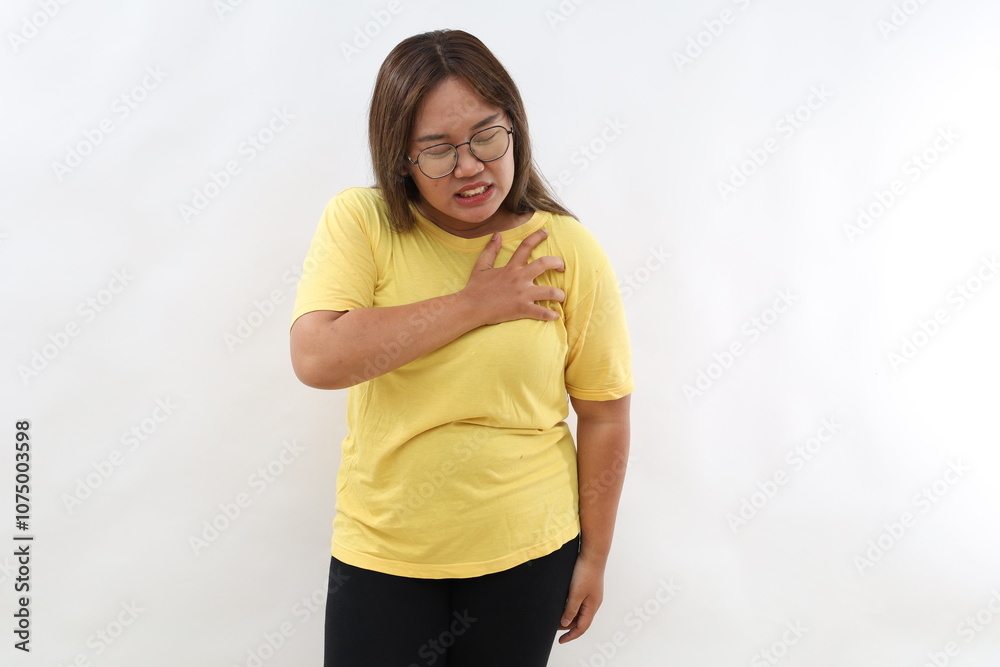 Sick asian woman with heart attack, pain, health problem holding touching her chest with hands isolated on white background. Human face expression