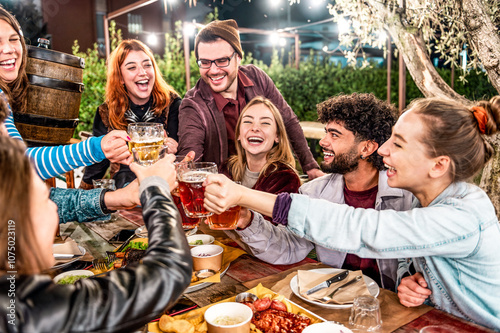 Young friends dining and having fun drinking beer together at barbecue backyard home party - Happy people eating bbq food at garden restaurant - Friendship, youth and party concept
