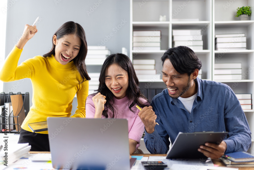Excited colleague celebrating success looking at laptop at office. Young entrepreneurs are happy about the good news they're reading on their laptop, start up business. Excited colleague celebrating success looking at laptop at office. Young entrepreneurs are happy about the good news they're reading on their laptop, start up business.