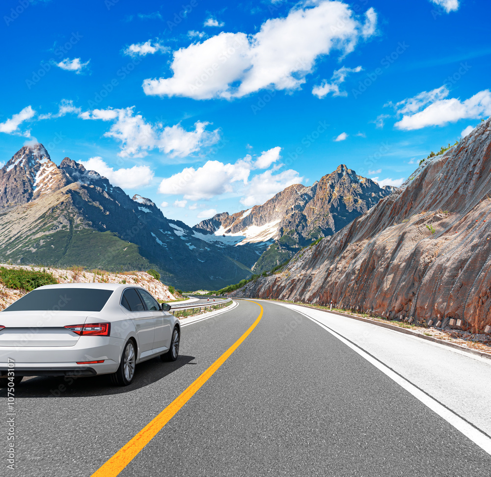 The car is driving along the highway surrounded by picturesque nature.