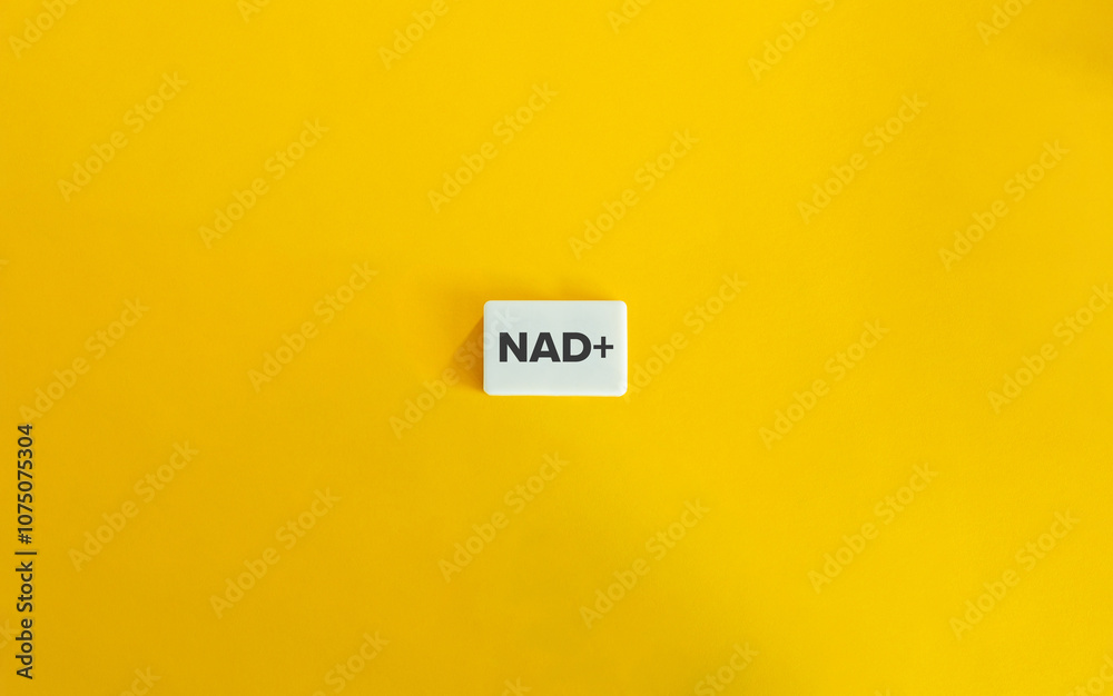 NAD+ (Nicotinamide Adenine Dinucleotide). Acronym and Text on Block Letter Tile on Yellow Background. Minimal Aesthetic. NAD+ (Nicotinamide Adenine Dinucleotide). Acronym and Text on Block Letter Tile on Yellow Background. Minimal Aesthetic.