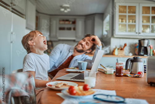 Father and daughter having fun at kitchen table