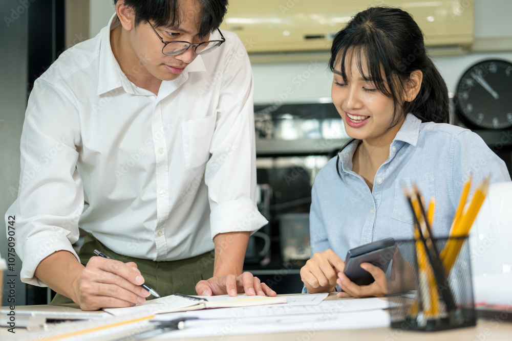Engineers looking and discussing over blueprints on desk. Engineers looking and discussing over blueprints on desk.