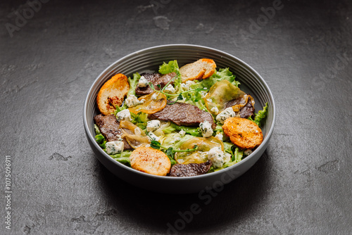 Gourmet salad with blue cheese, pear slices, toasted bread, and greens, perfect fusion of flavors