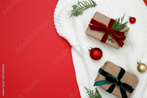 White knitted sweater with Christmas gifts on top, wrapped boxes creating festive holiday atmosphere photo