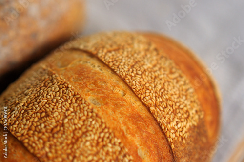 Closeup photo of crust with sesame seeds of home baked bread