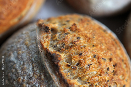 Closeup photo of crust with sesame seeds of home baked bread