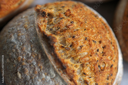 Closeup photo of crust with sesame seeds of home baked bread