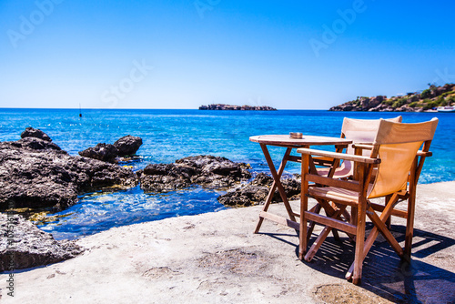 Chairs and table in a restaurant with a view of a sea in the background , Scenic view , Loutro village , Greece