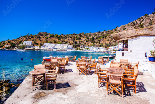 Chairs and table in a restaurant with a view of a sea in the background , Scenic view , Loutro village , Greece photo