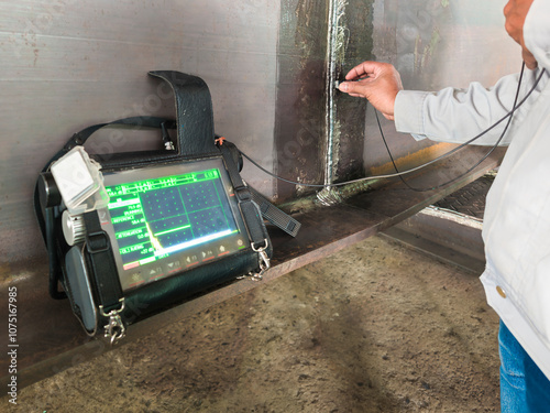 Inspectors are checking defects in welded steel h-beam add joint with process Ultrasonic testing (UT) of Non-Destructive Testing(NDT)