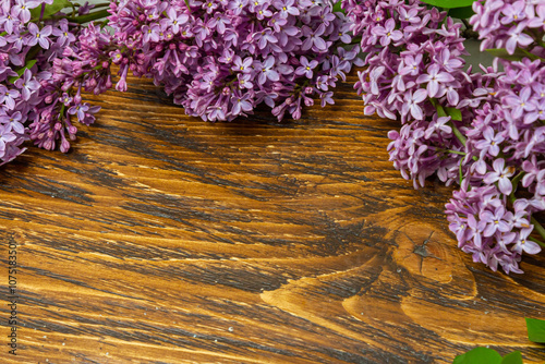Beautiful spring flowers lilac on a wooden vintage board with place for text. Syringa vulgaris. Happy Mother's Day greetings card.