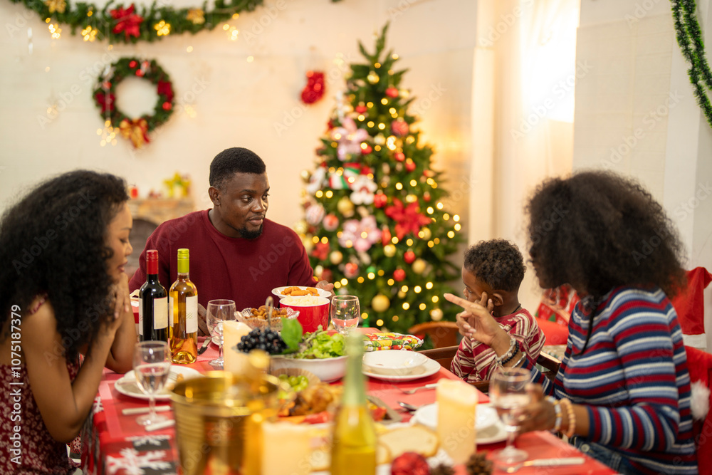 A cheerful holiday dinner scene with a diverse family enjoying a festive meal. Christmas decorations, gifts, and a lit Christmas tree create a cozy atmosphere, enhancing the warmth of the celebration. A cheerful holiday dinner scene with a diverse family enjoying a festive meal. Christmas decorations, gifts, and a lit Christmas tree create a cozy atmosphere, enhancing the warmth of the celebration.