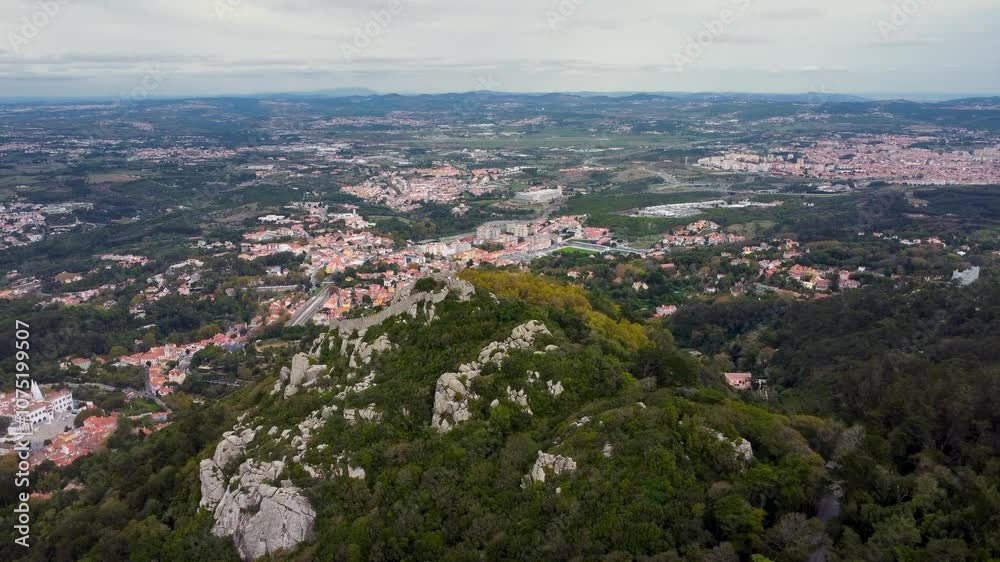 Aerial drone view of The Moorish Castle, Sintra, Portugal. Hilltop medieval castle built by the Moors in the 8th and 9th centuries. In background is Sintra city. Travel destination. Drone forward. Aerial drone view of The Moorish Castle, Sintra, Portugal. Hilltop medieval castle built by the Moors in the 8th and 9th centuries. In background is Sintra city. Travel destination. Drone forward.