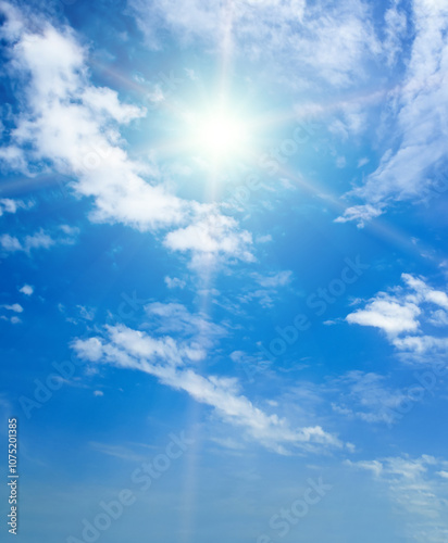 Blue sky with white clouds and bright sun.