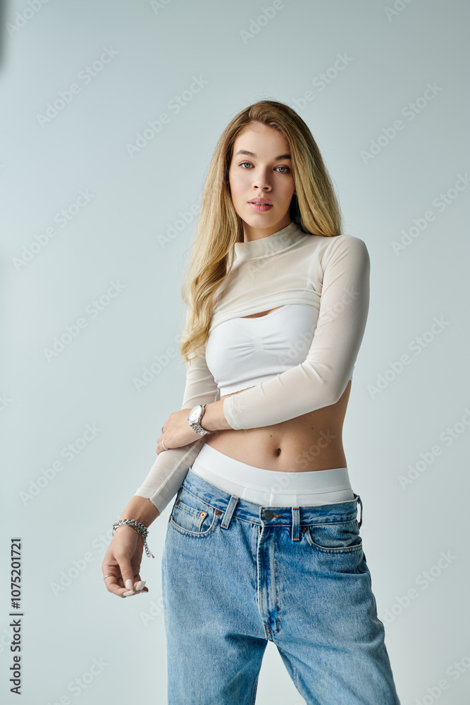 A stylish young woman poses confidently in a spacious studio, exuding elegance.