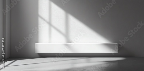 Minimalist white room with a window casting light on a ledge. photo