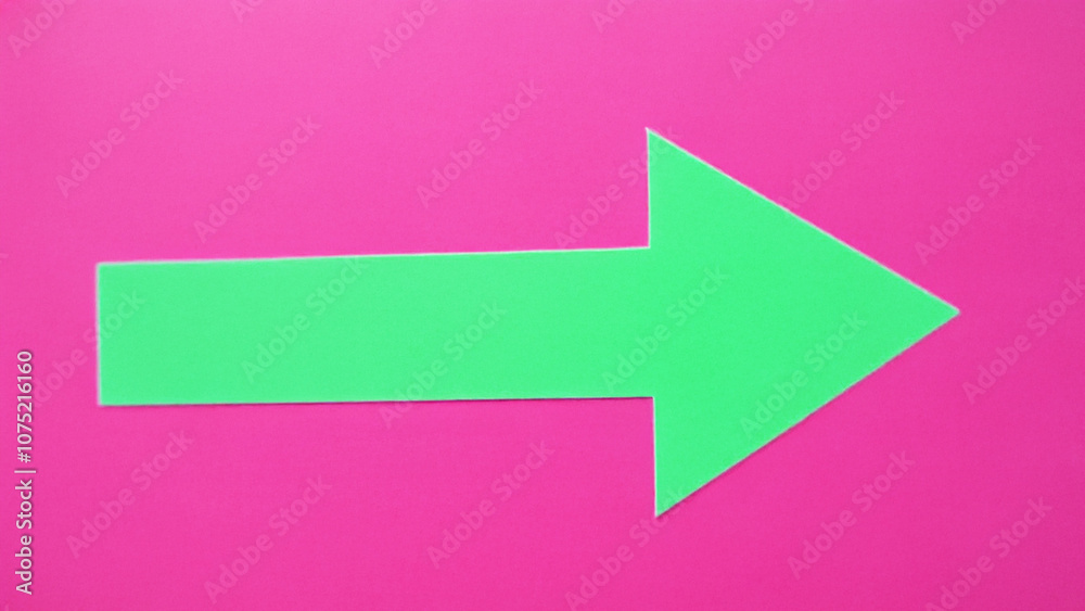 Bright Green Arrow on Vibrant Pink Background Bright Green Arrow on Vibrant Pink Background