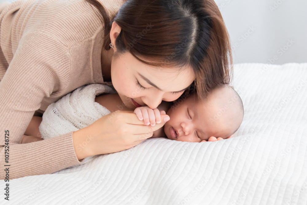 Asian beautiful mom motherhood lie down nursing, kissing newborn infant toddler, gently hold sleeping baby togetherin arm with love, infant sleep comfortably with safe and cuddle, mother taking care Asian beautiful mom motherhood lie down nursing, kissing newborn infant toddler, gently hold sleeping baby togetherin arm with love, infant sleep comfortably with safe and cuddle, mother taking care