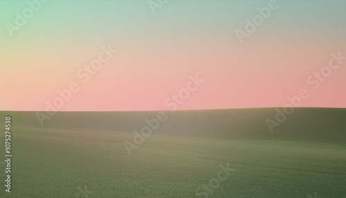 Soft pink and blue hues paint the sky over a rolling green field.