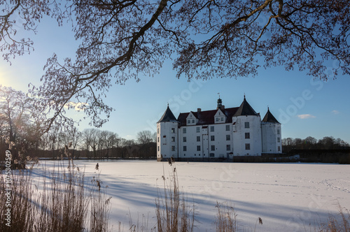 Fairytale Giücksburg castle in winter	. photo